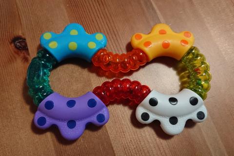 A plastic toy. The Thai for "a plastic toy" is "ของเล่นพลาสติก".