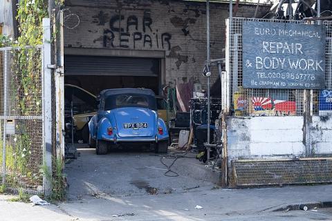 A blue car in a repair shop. The Thai for "a blue car in a repair shop" is "รถยนต์สีน้ำเงินในอู่ซ่อมรถ". A blue car in a repair shop. The Thai for "a blue car in a repair shop" is "รถยนต์สีน้ำเงินในอู่ซ่อมรถ".