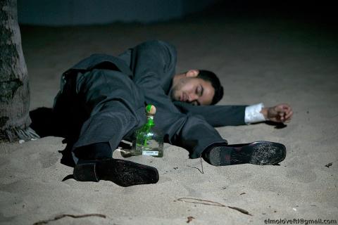 A drunk man sleeping on the beach. The Thai for "a drunk man sleeping on the beach" is "คนเมาหลับบนชายหาด". A drunk man sleeping on the beach. The Thai for "a drunk man sleeping on the beach" is "คนเมาหลับบนชายหาด".