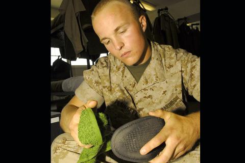 A soldier cleaning his shoes. The Thai for "a soldier cleaning his shoes" is "ทหารทำความสะอาดรองเท้าของเขา". A soldier cleaning his shoes. The Thai for "a soldier cleaning his shoes" is "ทหารทำความสะอาดรองเท้าของเขา".