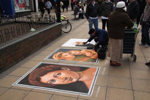 An artist painting on the sidewalk. The Thai for "an artist painting on the sidewalk" is "ศิลปินวาดรูปบนทางเท้า". An artist painting on the sidewalk. The Thai for "an artist painting on the sidewalk" is "ศิลปินวาดรูปบนทางเท้า".