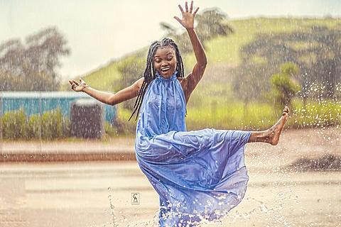A woman playing in the rain. The Thai for "a woman playing in the rain" is "ผู้หญิงเล่นน้ำฝน". A woman playing in the rain. The Thai for "a woman playing in the rain" is "ผู้หญิงเล่นน้ำฝน".