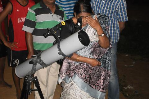 A woman looking through a telescope. The Thai for "a woman looking through a telescope" is "ผู้หญิงส่องกล้องดูดาว". A woman looking through a telescope. The Thai for "a woman looking through a telescope" is "ผู้หญิงส่องกล้องดูดาว".